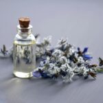 Home Close-up of a lavender oil bottle with dried flowers for aromatherapy. Perfect for wellness themes.